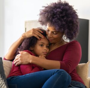 Parent hugging their child
